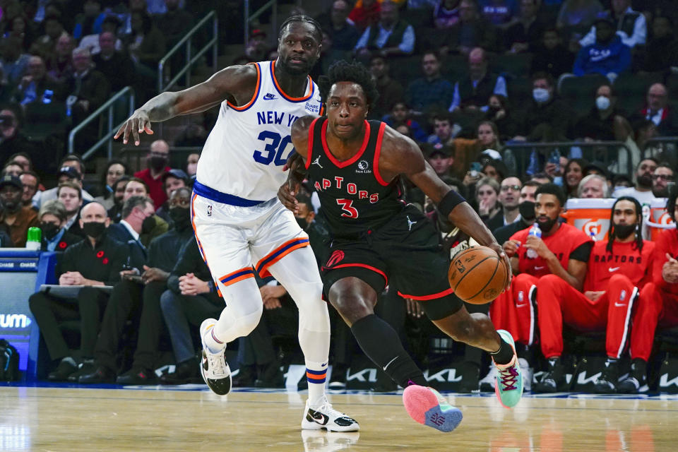 Toronto Raptors' OG Anunoby (3) drives past New York Knicks' Julius Randle (30) during the first half of an NBA basketball game Monday, Nov. 1, 2021, in New York. (AP Photo/Frank Franklin II)