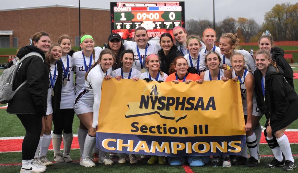 The Clinton Comets pose with their championship banner after winning Section III's Class C field hockey final Sunday.