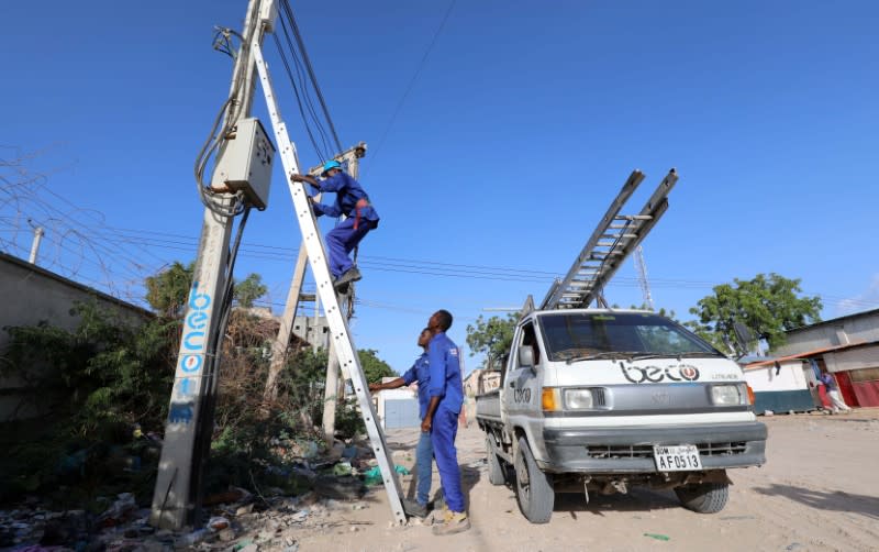 Technicians from the Benadir Electricity Company (BECO) work on a routine maintenance on their power cables in Mogadishu