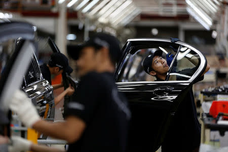 Workers put together doors for a locally assembled new BMW 7 Series on the production line at a Gaya Motor assembly plant in Jakarta, Indonesia November 30, 2016. REUTERS/Darren Whiteside