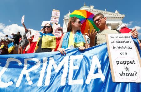 People attend 'Helsinki Calling' protest ahead of meeting between the U.S. President Donald Trump and Russian President Vladimir Putin in Helsinki, Finland July 15, 2018. REUTERS/Ints Kalnins