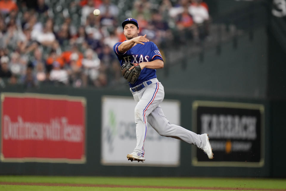 Texas Rangers shortstop Corey Seager attempts to throw out Houston Astros' J.J. Matijevic, who singled during the fourth inning of a baseball game Tuesday, Sept. 6, 2022, in Houston. (AP Photo/Eric Christian Smith)