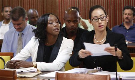 Jamaica's Olympic sprinter Sherone Simpson (front L), who tested positive for doping at the Jamaican Championships in 2013, sits with her attorney Dianne Chai (front R), as they wait for the beginning of the hearing before the country's anti-doping commission in Kingston January 7, 2014. REUTERS/Gilbert Bellamy