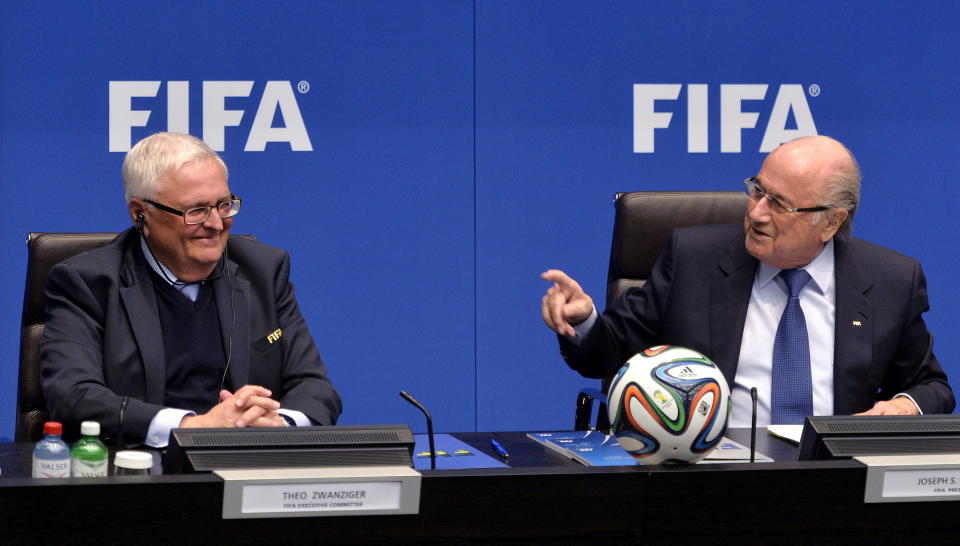 FIFA President Joseph S. Blatter, right, and Theo Zwanziger, left, from germany, Member Executive Committee, left, chat during a press conference at the conclusion of the meeting of the FIFA Executive Committee at the Home of FIFA in Zurich, Switzerland, Friday, March 21, 2014. Among other topics, the FIFA Executive Committee covered sports political matters including an update on the workers' welfare in Qatar. (AP Photo/Keystone,Walter Bieri)