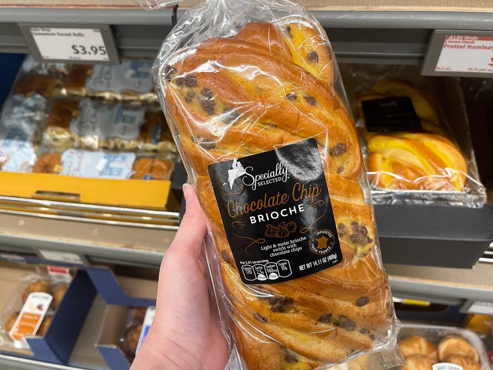 The writer holds a wrapped loaf of chocolate-chip brioche bread