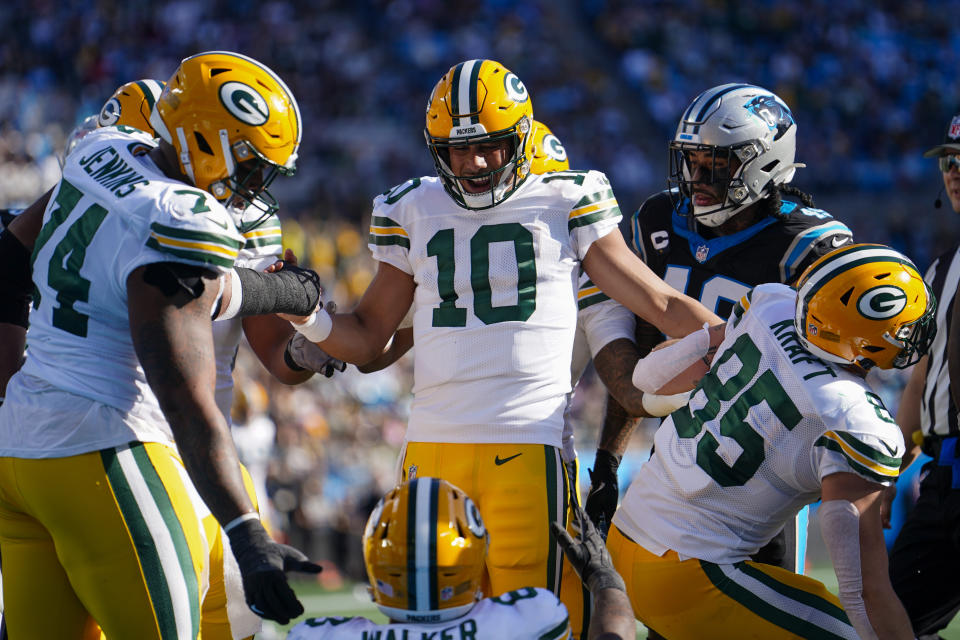 Green Bay Packers quarterback Jordan Love celebrates after scoring against the Carolina Panthers during the first half of an NFL football game Sunday, Dec. 24, 2023, in Charlotte, N.C. (AP Photo/Jacob Kupferman)