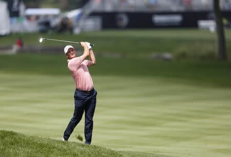 Aug 3, 2014; Akron, OH, USA; Justin Rose hits his approach shot on the first hole during the final round of the WGC-Bridgestone Invitational golf tournament at Firestone Country Club - South Course. Joe Maiorana-USA TODAY Sports