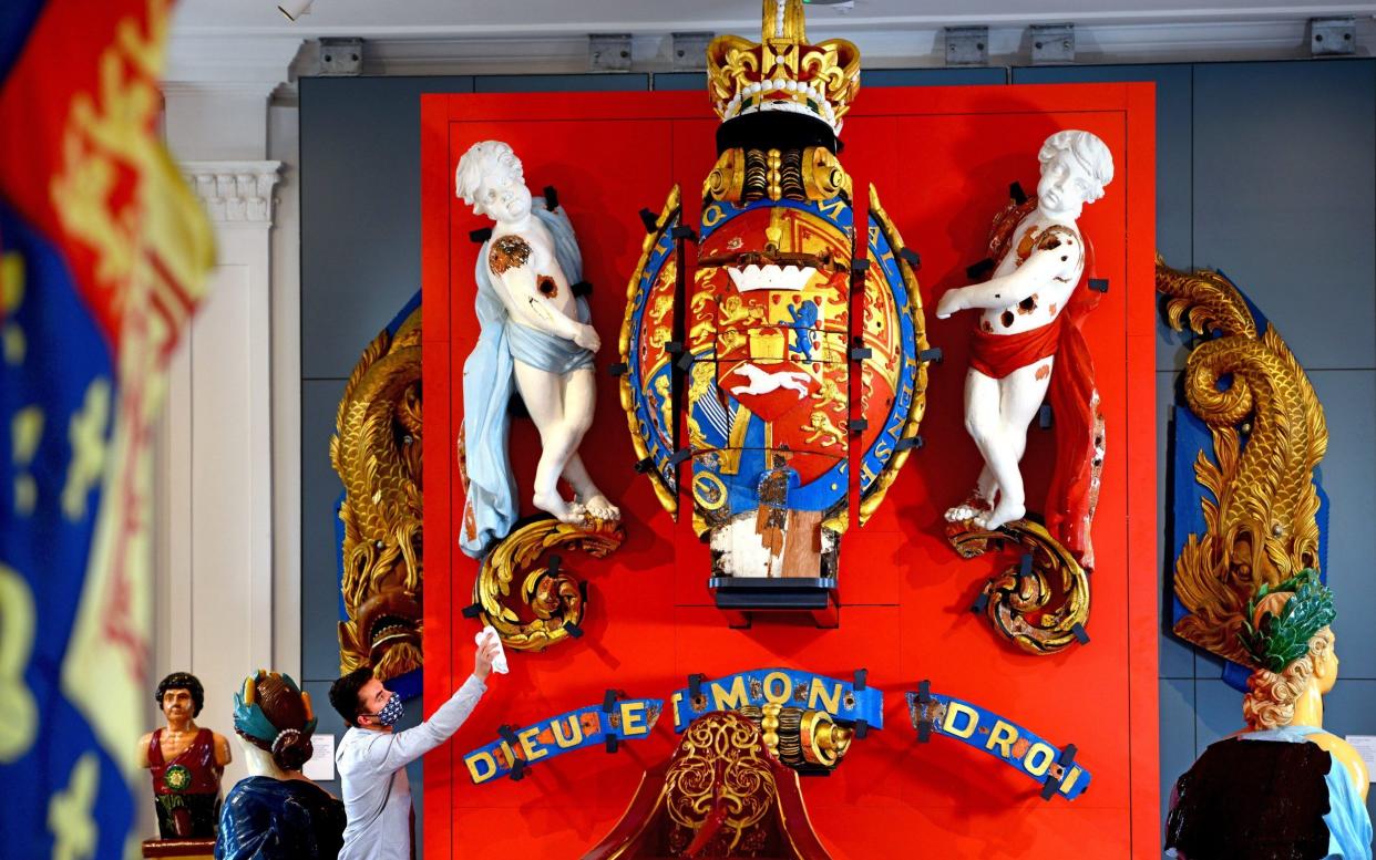 A curator at the Victory Gallery in Portsmouth's Historic Dockyard polishes the newly-restored HMS Victory figurehead - Roger Arbon/Solent News & Photo Agency