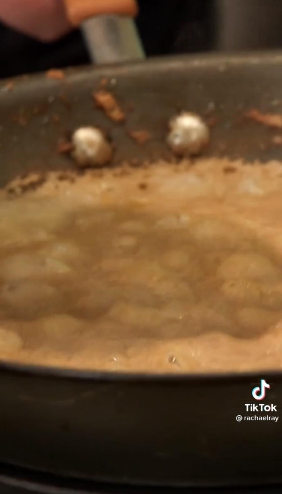 A burnt edge on the beans inside the skillet