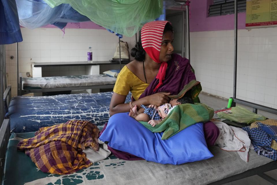Sandhya Shivappa, 25, breastfeeds her baby girl as she rests a day after her delivery at a government maternity hospital which runs on rooftop solar power, in Raichur, India, Wednesday, April 19, 2023. Government Maternity installed rooftop solar panels about a year ago and can now depend on constant electricity that keeps the lights on, patients and staff comfortable and vaccines and medicines safely refrigerated. (AP Photo/Aijaz Rahi)