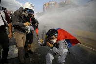 <p>Demonstrators clash with riot security forces while rallying against President Nicolas Maduro in Caracas, Venezuela, May 27, 2017. (Carlos Barria/Reuters) </p>