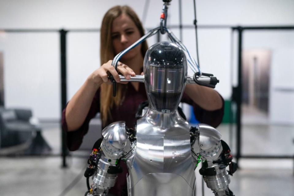 An AI engineer works on humanoid robot. AP