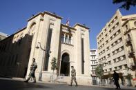 Lebanese army soldiers walk as they secure the area outside the parliament building in downtown Beirut November 13, 2015 where the Lebanese national flag flies at half staff in a sign of mourning after two blasts on Thursday hit a residential and commercial area in a southern suburb of Beirut, Lebanon. REUTERS/Jamal Saidi