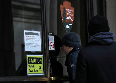 People look inside as a closed sign is seen on a door at Federal Hall National Memorial, as the partial U.S. government shutdown continues in New York, U.S., January 7, 2019. REUTERS/Brendan McDermid