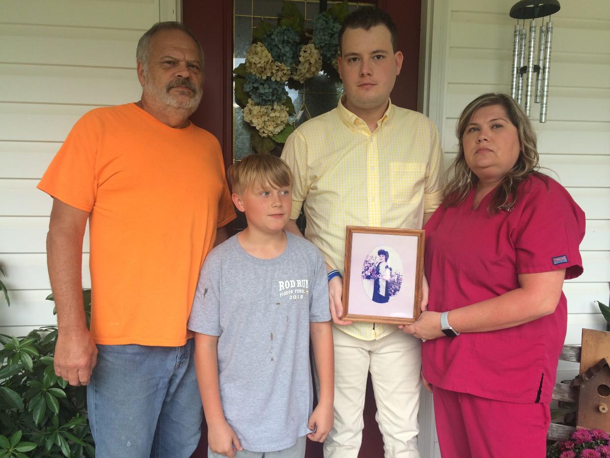 Pictured, from left Charles Newberry, Caden Newberry, D.J. Tucker, and Brandy Richardson. Tucker is the son of Karie Ann Newberry, who was shot and killed in 1993. Charles is Karie Ann's father and Brandy is her sister. Tucker holds a photo of his mother.