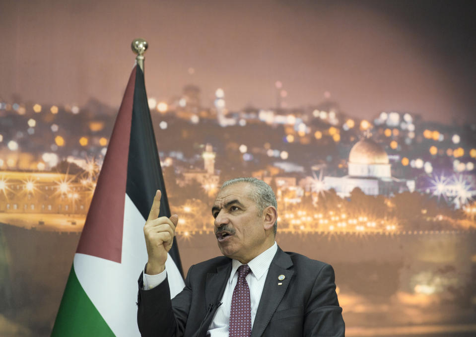 Palestinian Prime Minister Mohammad Shtayyeh italks during an interview with The Associated Press, at his office in the West Bank city of Ramallah, Tuesday, April 16, 2019. Stayyeh accused the United States of declaring "financial war" on his people and said an American peace plan purported to be in the works will be "born dead." (AP Photo/Nasser Nasser)