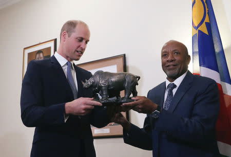 Britain's Prince William receives a gift from Namibia's Vice President Nangolo Mbumba during their meeting in Windhoek, Namibia September 24, 2018. REUTERS/Mike Hutchings