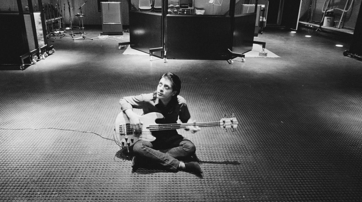  1st MAY: Mick Karn from Japan posed with his bass guitar sitting on the floor of Basing Street Studios in West London in May 1982. (Photo by Fin Costello/Redferns) 