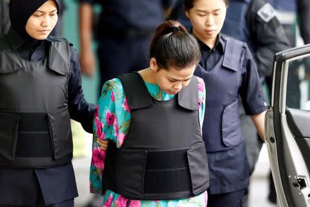 FILE PHOTO: Indonesian Siti Aisyah who is on trial for the killing of Kim Jong Nam, the estranged half-brother of North Korea's leader, is escorted as she leaves at the Department of Chemistry in Petaling Jaya, near Kuala Lumpur, Malaysia October 9, 2017. REUTERS/Lai Seng Sin