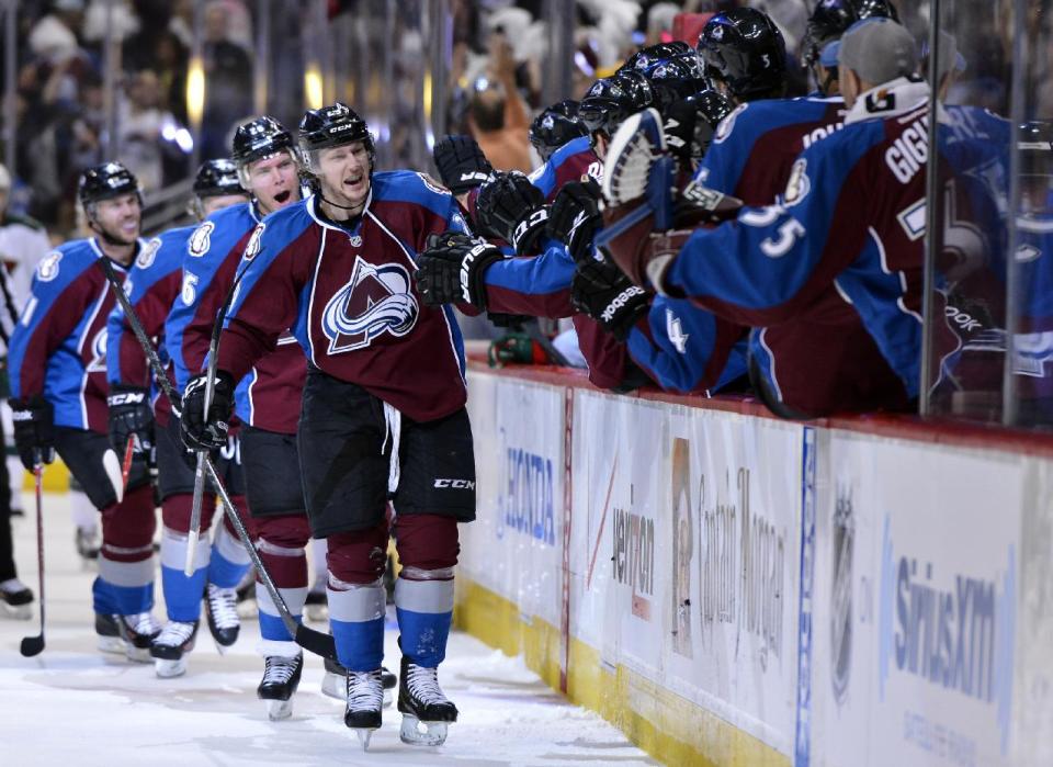 Colorado Avalanche center Nathan MacKinnon (29) celebrates a goal against the Minnesota Wild in the first period of Game 2 of an NHL hockey first-round playoff series on Saturday, April 19, 2014, in Denver. (AP Photo/Jack Dempsey)