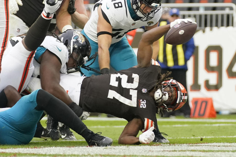 Cleveland Browns running back Kareem Hunt (27) pushes through the Jacksonville Jaguars defense for a 4-yard rushing touchdown during the second half of an NFL football game, Sunday, Dec. 10, 2023, in Cleveland. (AP Photo/Sue Ogrocki)