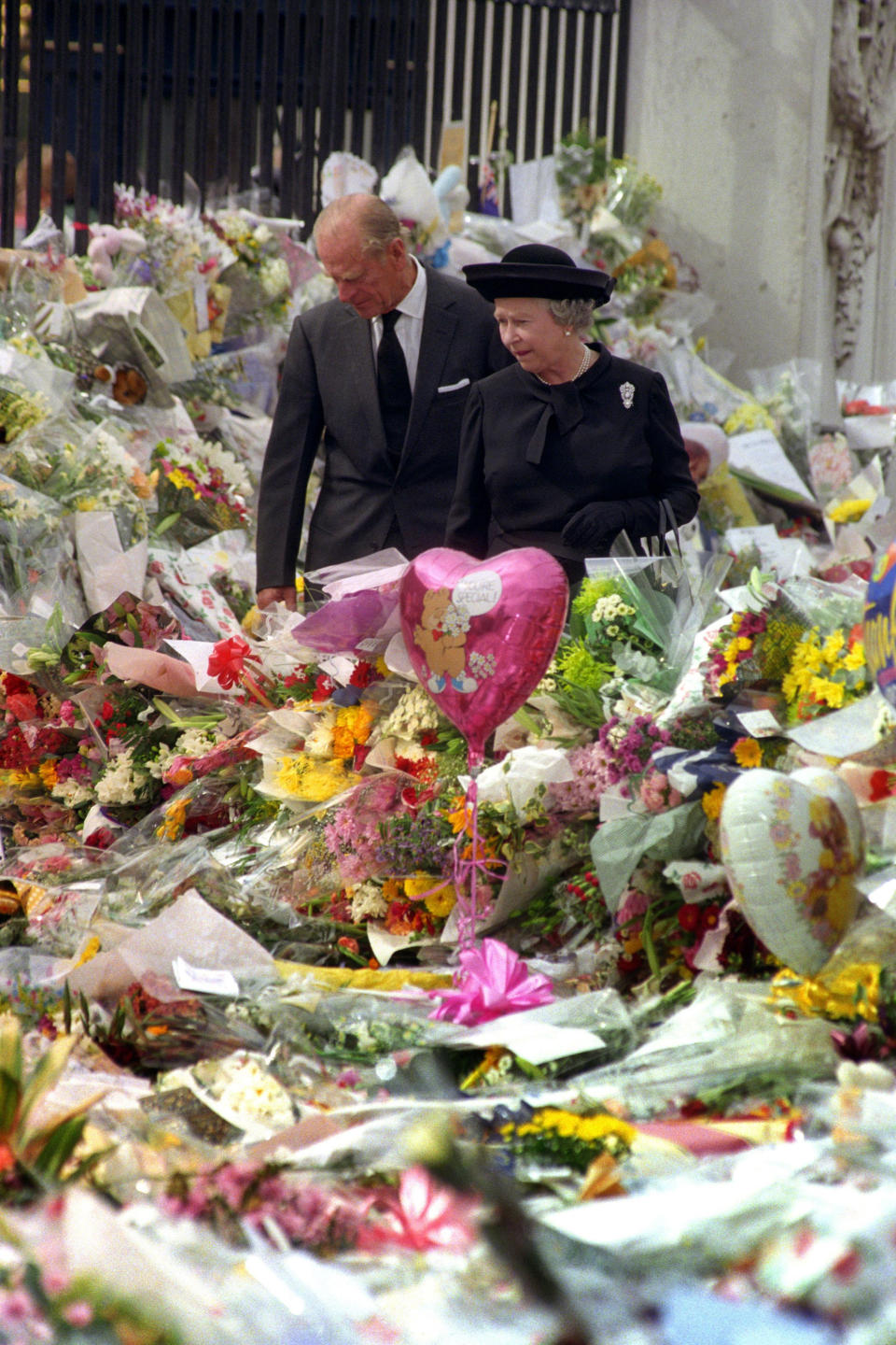 Queen Elizabeth II and the Duke of Edinburgh viewing the floral tributes to Diana, Princess of Wales, at Buckingham Palace in 1997. (PA)