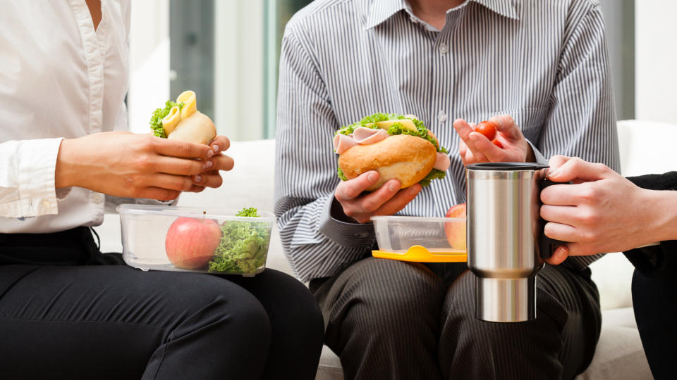 coworkers eating tupperware lunches together