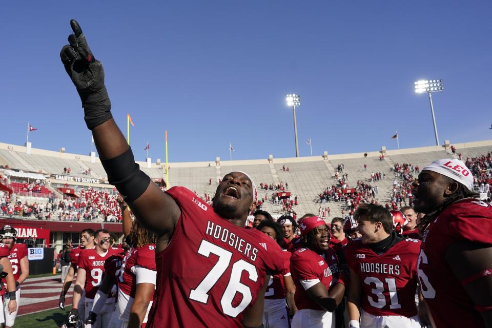 Indiana offensive lineman Matthew Bedford (76) celebrates with teammates after they defeated Wisconsin in an NCAA college football game, Saturday, Nov. 4, 2023, in Bloomington, Ind. (AP Photo/Darron Cummings)