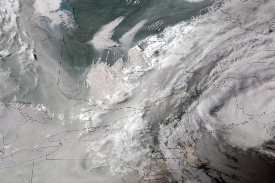 In this GOES-16 GeoColor satellite image taken Monday, June 5, 2023 at 7 p.m. EDT and provided by CIRA/NOAA, smoke from wildfires burning in Quebec, Canada, top center, drifts southward. (CIRA/NOAA via AP)