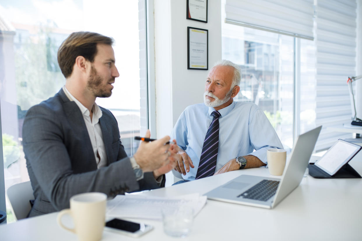 Senior businessman collaborating with younger manager