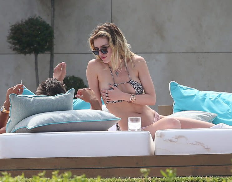 Scott Disick squeezes girlfriend Bella Thornes breast as they sunbathe in Cannes