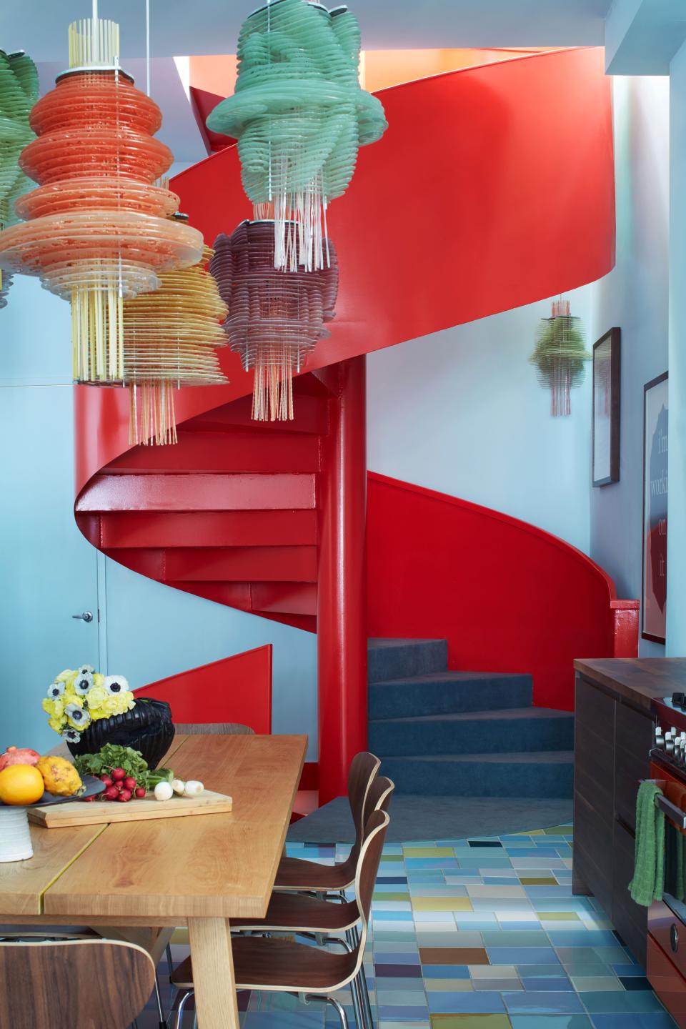 Pardo replaced the existing staircase with a spiral design in scarlet; the walls are painted in a hand-mixed combination of Behr colors.