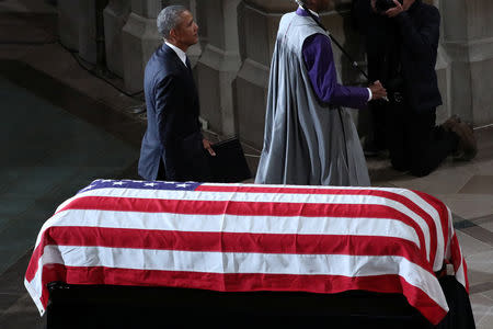 Former U.S. President Barack Obama walks past the casket at the memorial service of U.S. Senator John McCain (R-AZ) at National Cathedral in Washington, U.S., September 1, 2018. REUTERS/Chris Wattie