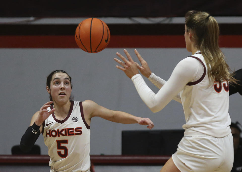 Virginia Tech's Georgia Amoore, left, waits for a pass from Elizabeth Kitley (33) during the first half of the team's NCAA college basketball game against North Carolina State on Sunday, Feb. 19, 2023, in Blacksburg, Va. (Matt Gentry/The Roanoke Times via AP)