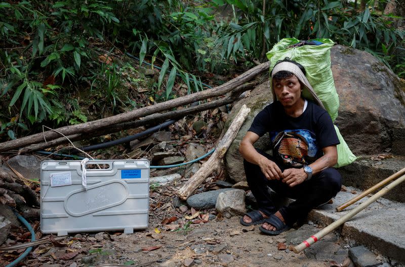 Polling officers and porters carry VVPAT and EVM to a remote village in Shillong