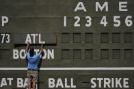 An attendance places the Atlanta Braves sign on the Green Monster score board before a spring training baseball game against the Boston Red Sox on Monday, March 1, 2021, in Fort Myers, Fla. (AP Photo/Brynn Anderson)