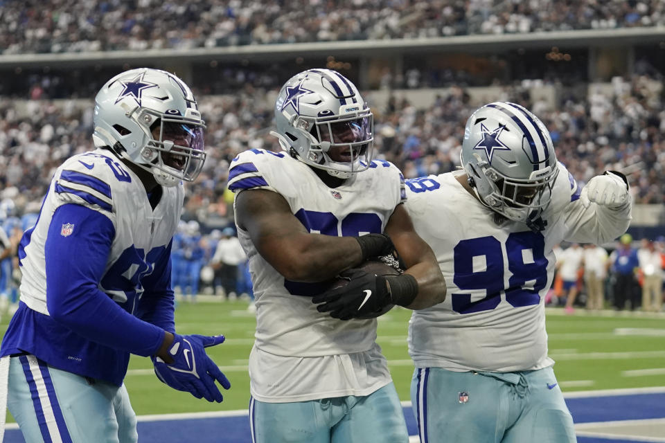 Dallas Cowboys defensive end Dorance Armstrong, center, celebrates a fumble recovery with teammates during the second half of an NFL football game against the Detroit Lions, Sunday, Oct. 23, 2022, in Arlington, Texas. (AP Photo/Tony Gutierrez)