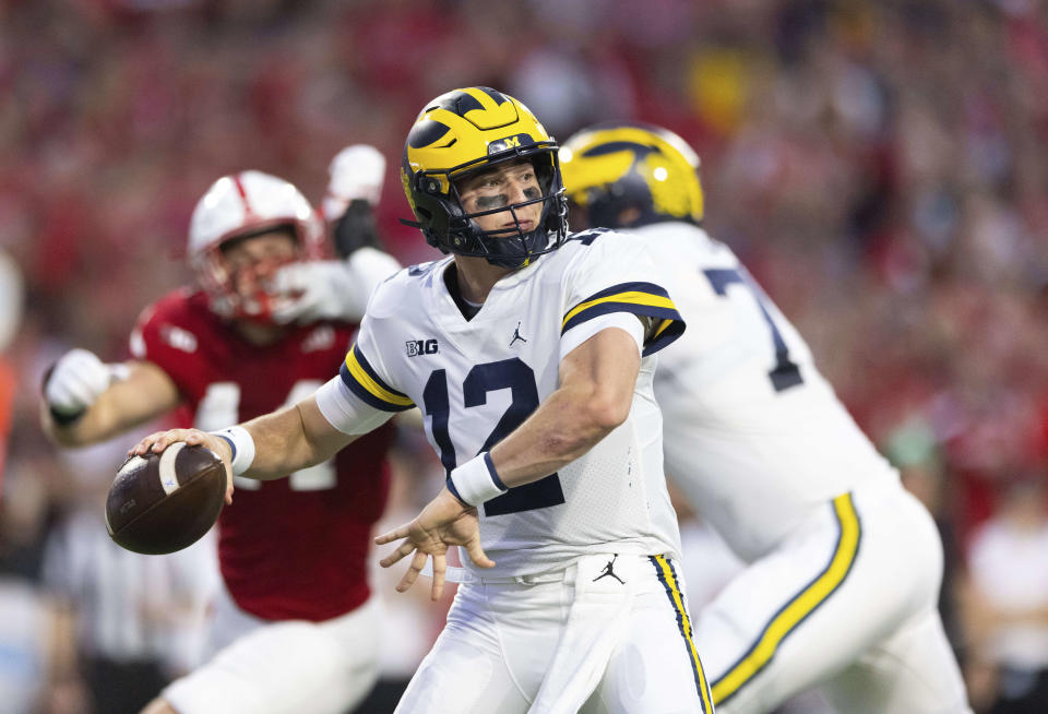 Michigan quarterback Cade McNamara (12) passes the ball against Nebraska during the first half of an NCAA college football game Saturday, Oct. 9, 2021, at Memorial Stadium in Lincoln, Neb. (AP Photo/Rebecca S. Gratz)