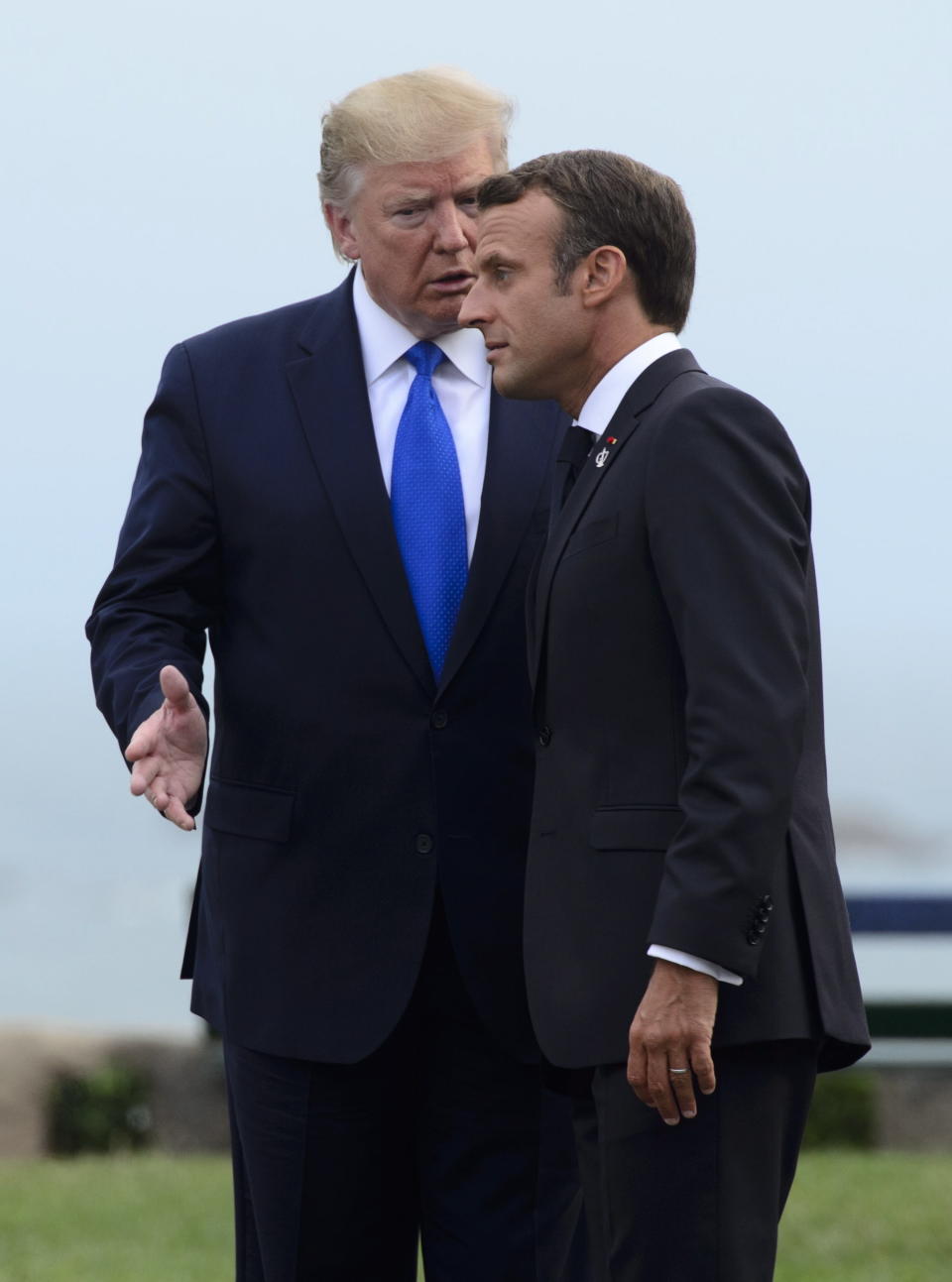 U.S. President Donald Trump, left, is greeted by the President of France Emmanuel Macron as he arrives to the G7 Summit in Biarritz, France, Saturday, Aug. 24, 2019. (Sean Kilpatrick/The Canadian Press via AP)