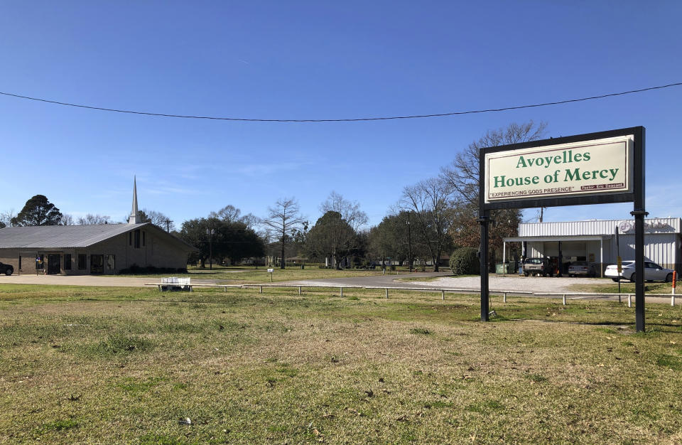 This photo shows a sign and an exterior of the Avoyelles House of Mercy in Marksville, La., Sunday, Jan. 6, 2019. It was supposed to be a fun, post-Christmas trip to Disney World for 14-year-old Jeremiah Warren and his friends from the church in this small Louisiana town - "clean fun" as Warren's aunt described it. But then word came of a fiery crash on a Florida highway that killed seven people, including five children from this area traveling in a church van. (AP Photo/Rebecca Santana)