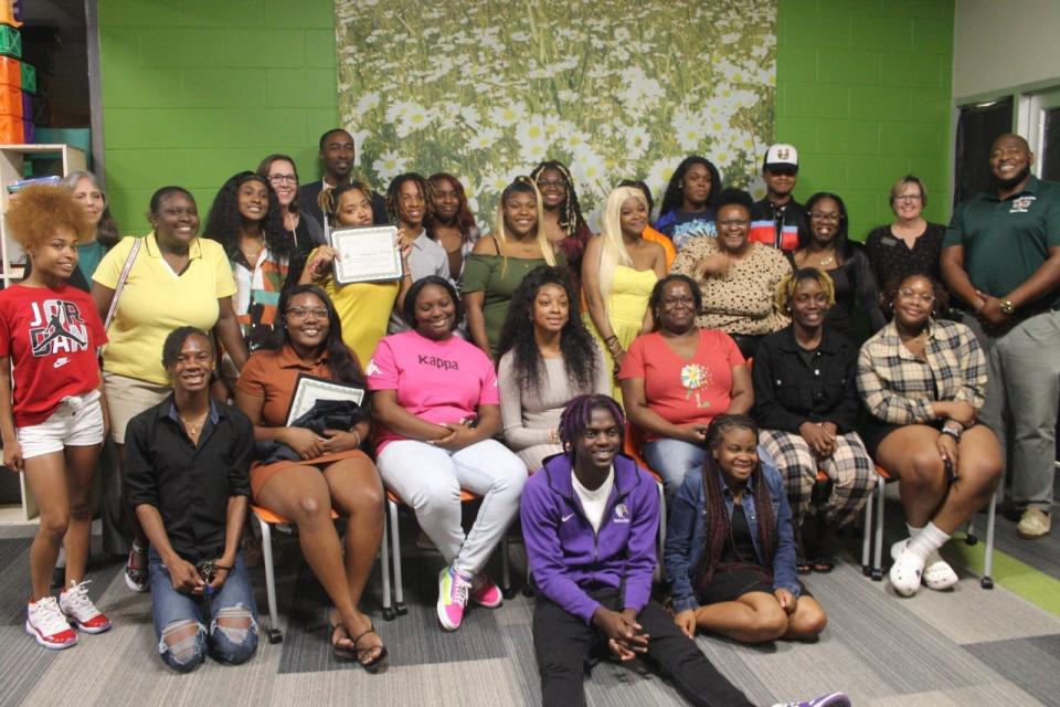 Students who participated in Eastside High School's Medical Skills Program pose for a picture with faculty and staff.
(Photo: Photo by Voleer Thomas/For The Guardian)