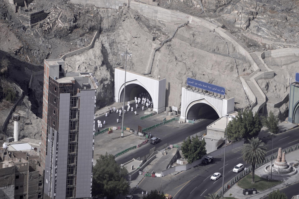 Pilgrims cross a tunnel on their way to the Grand mosque in the Muslim holy city of Mecca, Saudi Arabia, Sunday, June 25, 2023. Saudi Arabia is pumping billions of dollars into the holy city of Mecca to meet its ambitious economic targets, with high-end hotels, apartment blocks, retailers and restaurants planned for areas around the Grand Mosque. (AP Photo/Amr Nabil)