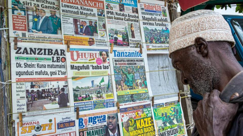 A man reads newspapers at a kiosk in Zanzibar&#39;s town on October 24, 2020