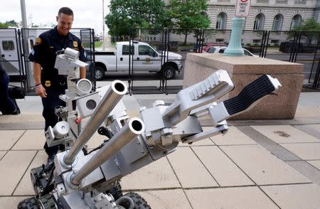 Cleveland police bomb squad technician Sgt. Tim Maffo-Judd demonstrates a Remotec F5A explosive ordnance device robot during a demonstration of police capabilities across the street from city hall near the site of the Republican National Convention in Cleveland, Ohio July 14, 2016. REUTERS/Rick Wilking