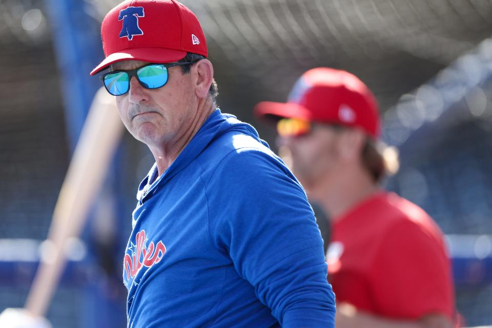 Philadelphia Phillies manager Rob Thomson (59) directs batting practice before a game against the New York Yankees at BayCare Ballpark during spring training in Clearwater, Fla.
