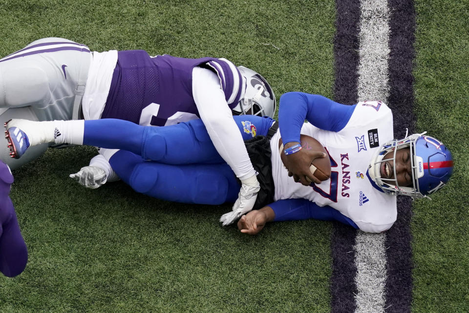 Kansas quarterback Jalon Daniels (17) is sacked by Kansas State defensive end Felix Anudike (91) during the second half of an NCAA football game Saturday, Oct. 24, 2020, in Manhattan, Kan. (AP Photo/Charlie Riedel)