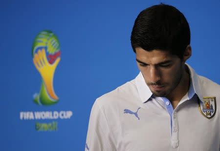 Uruguay's national soccer team player Luis Suarez arrives at a news conference prior a training session at the Dunas Arena soccer stadium in Natal, June 23, 2014. REUTERS/Carlos Barria