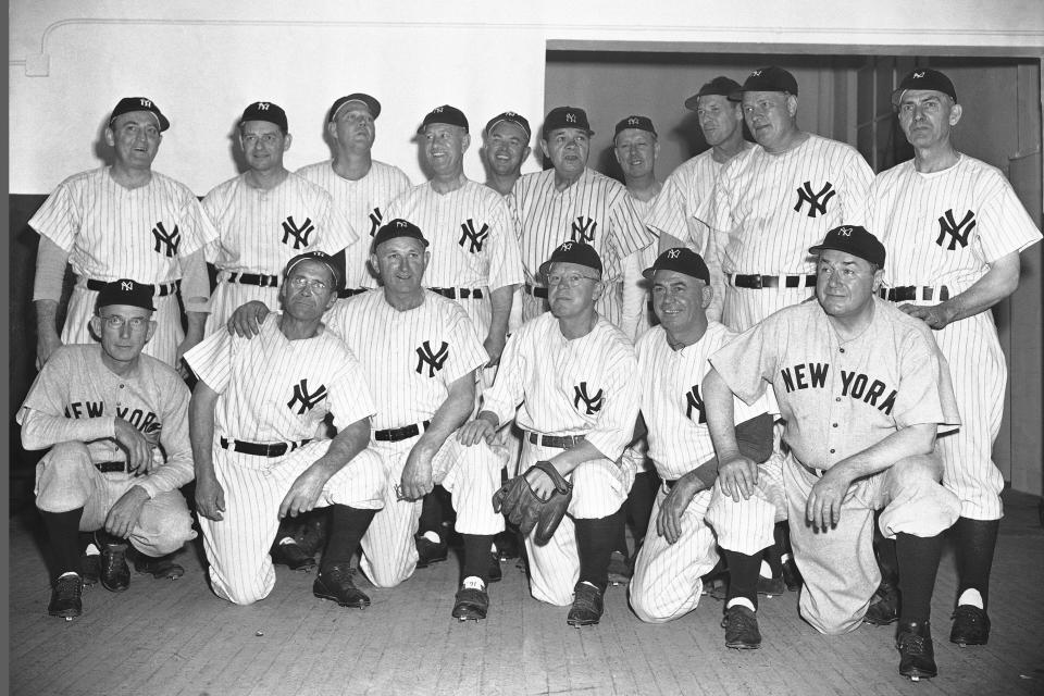 FILE — Babe Ruth, rear fifth from right, and members of the 1923 New York Yankees gather in New York's Yankee Stadium June 13, 1948, prior to ceremonies marking the 25th anniversary of the opening of the stadium. The players in front from left are: Sam Jones, Wally Schang, Carl Mays, Whitey Witt, Fred Hoffman, and Mike McNally. Standing from left are: Pinky Haines, Waite Hoyt, George Pipgras, Joe Bush, Oscar Roettger, Babe Ruth, Joe Dugan, Bob Meusel, Wally Pipp and Elmer Smith. The 100th anniversary of the original Yankee Stadium is marked Tuesday, April 18, 2023, a ballpark that revolutionized baseball with its grandeur and the success of the team. (AP Photo/File)