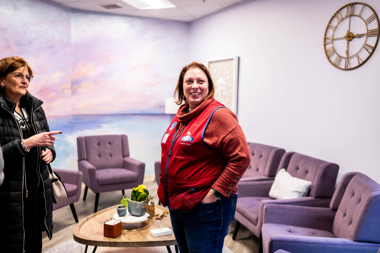 Randi Smuckler, left, president of the Domestic Violence Project Board of Directors, and a Lowe's employee tour the agency's renovated space.