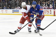 Detroit Red Wings defenseman Filip Hronek (17) and New York Rangers right wing Jesper Fast (17) compete for the puck during the third period of an NHL hockey game Friday, Jan. 31, 2020, in New York. (AP Photo/Sarah Stier)